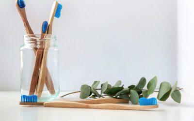 blue and white toothbrush in clear glass jar